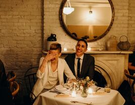 Couple at their reception watching the wedding slideshow