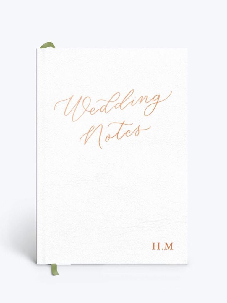 white wedding notebook with green ribbon bookmark