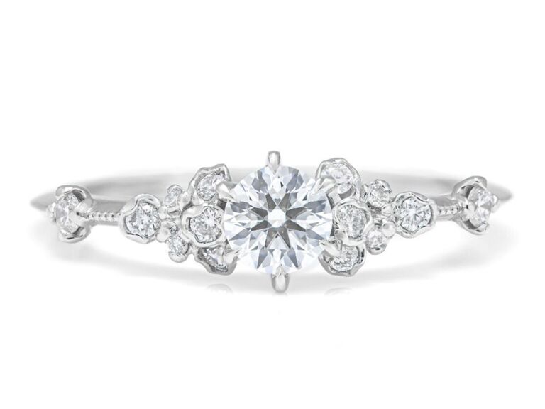 catbird flower engagement ring with round diamond center stone side diamond blossoms and platinum band