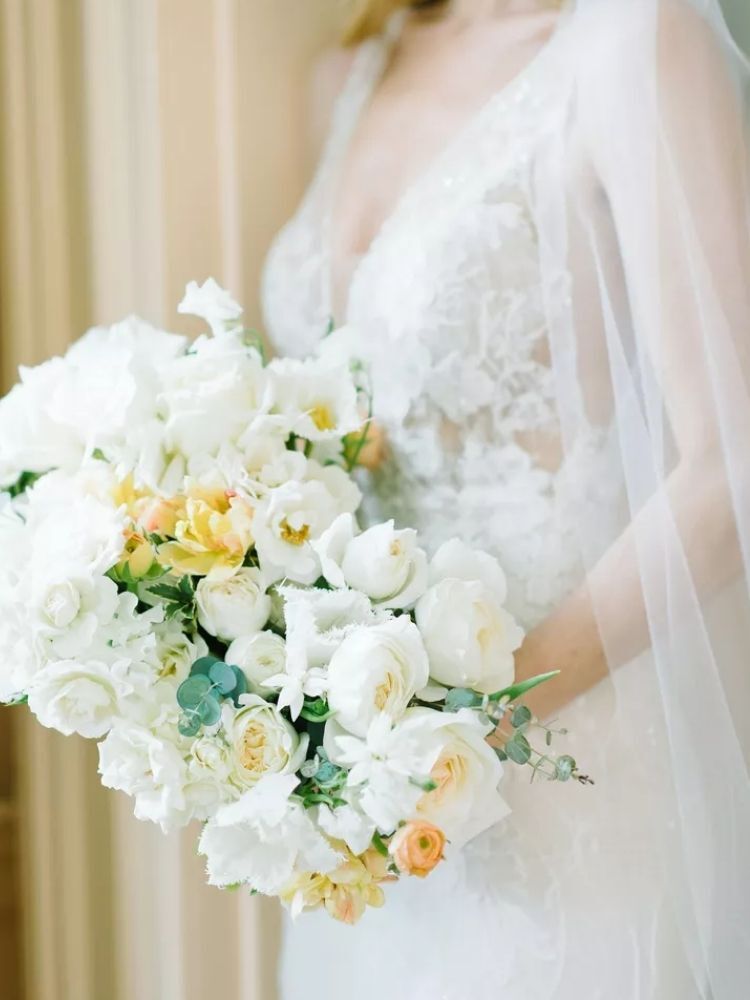 Bride holding white bouquet with fringe tulips