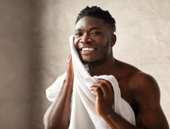 Man wiping face with towel, men's grooming tips for wedding
