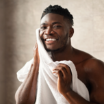 Man wiping face with towel, men's grooming tips for wedding