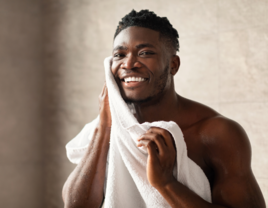 Man wiping face with towel, men's grooming tips for wedding