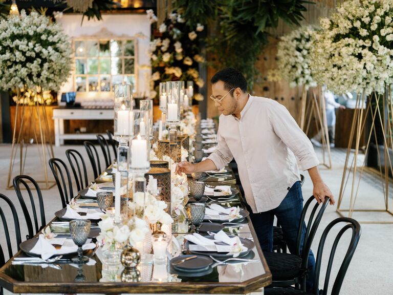 Event designer Nestor Gamez setting wedding reception table