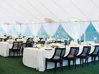 A tented outdoor wedding reception space