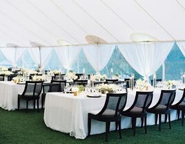 A tented outdoor wedding reception space