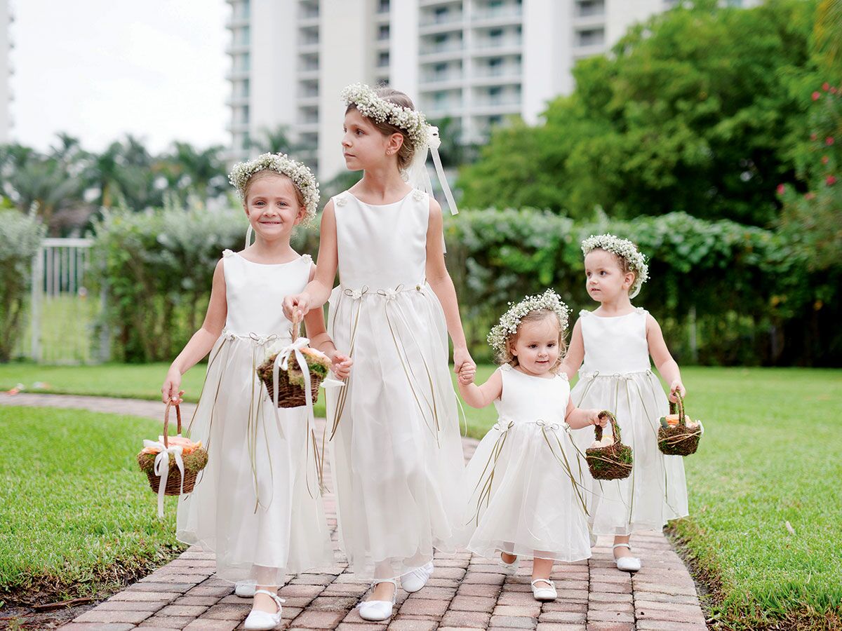 Flower girls in white dresses and flower crowns