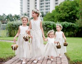 Flower girls in white dresses and flower crowns