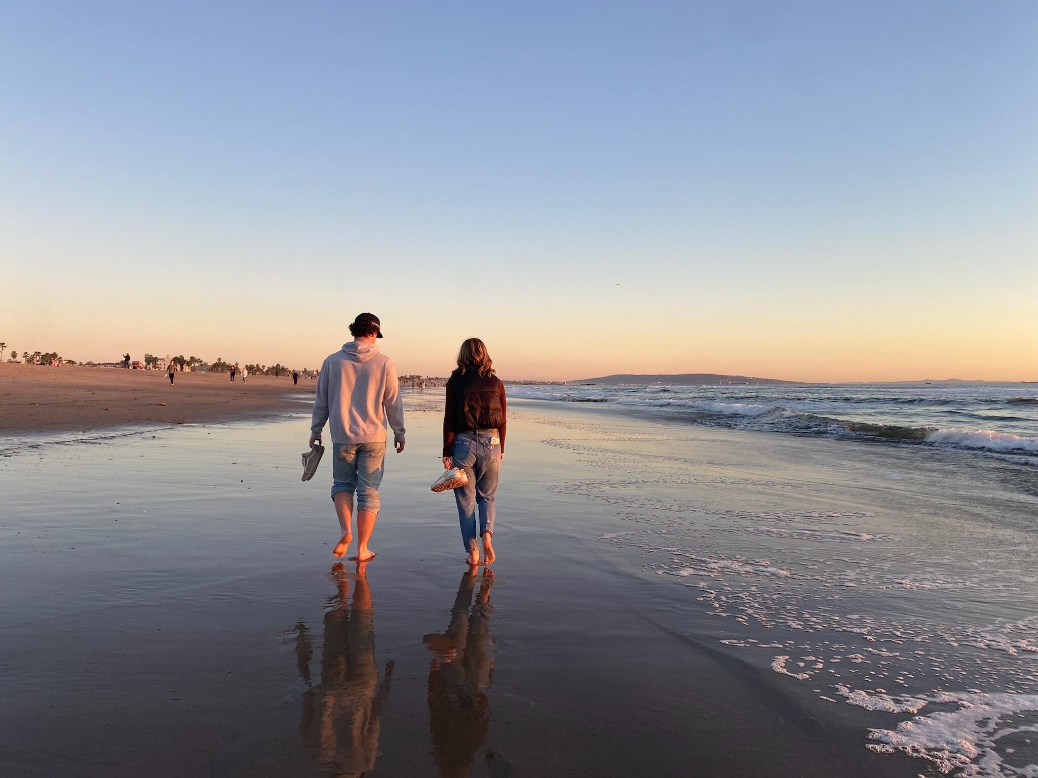 One of Hailey's friends, secretly took this photo of Nick and Hailey walking on the beach. Nick would ask Hailey on a date the next day.