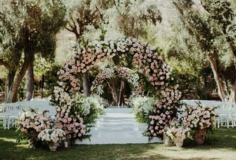 rose covered wedding ceremony arch 