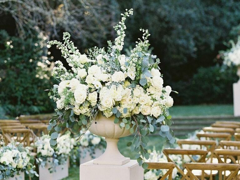 ceremony flower arrangement in urn with stock blooms