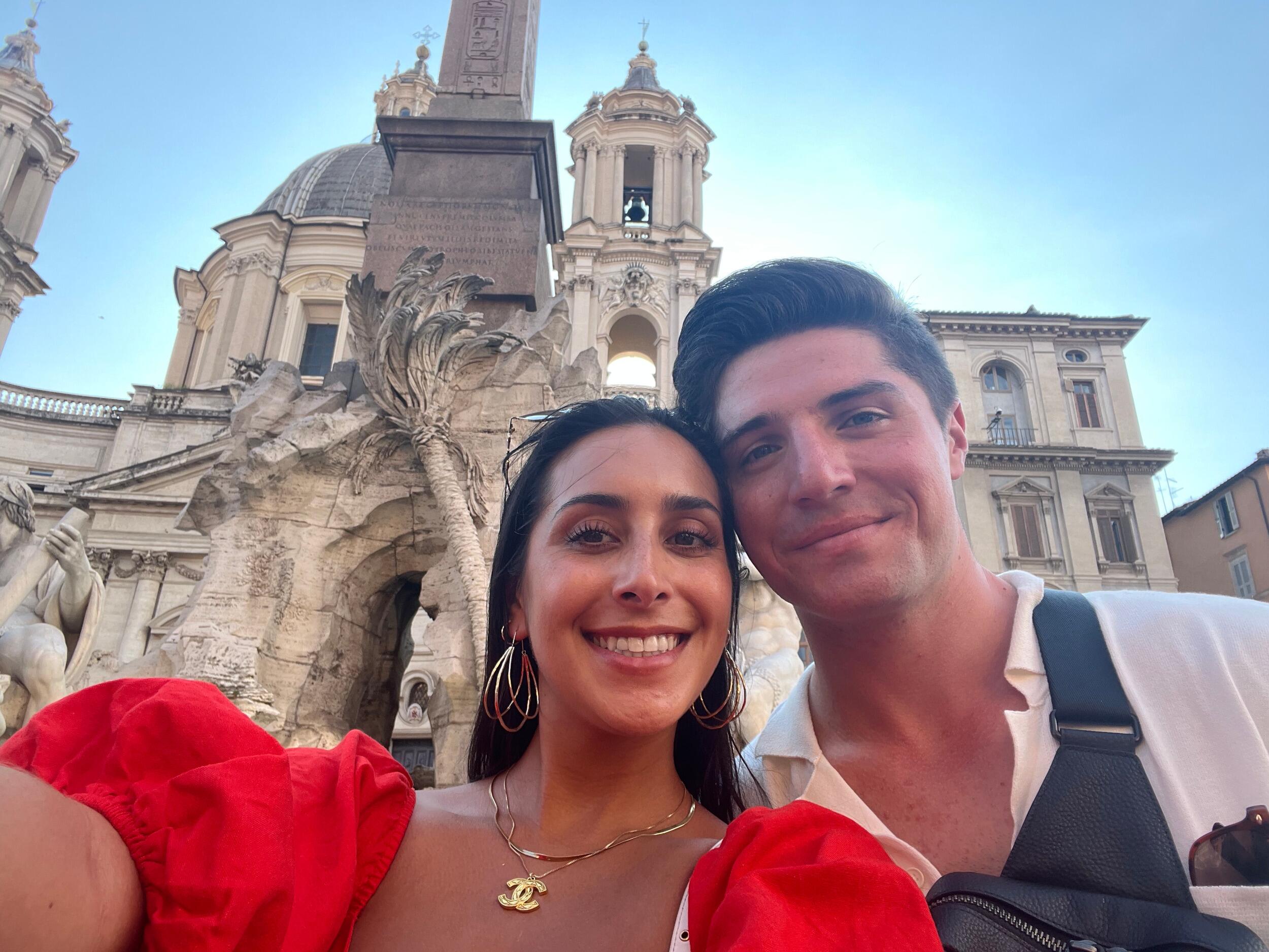 Stop 4 - Rome, Italy. Lila and Tyler take a stroll through Piazza Navona on their way to a date night in Trastevere.
