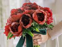 winter wedding bouquet with red peonies, greenery and green velvet ribbons