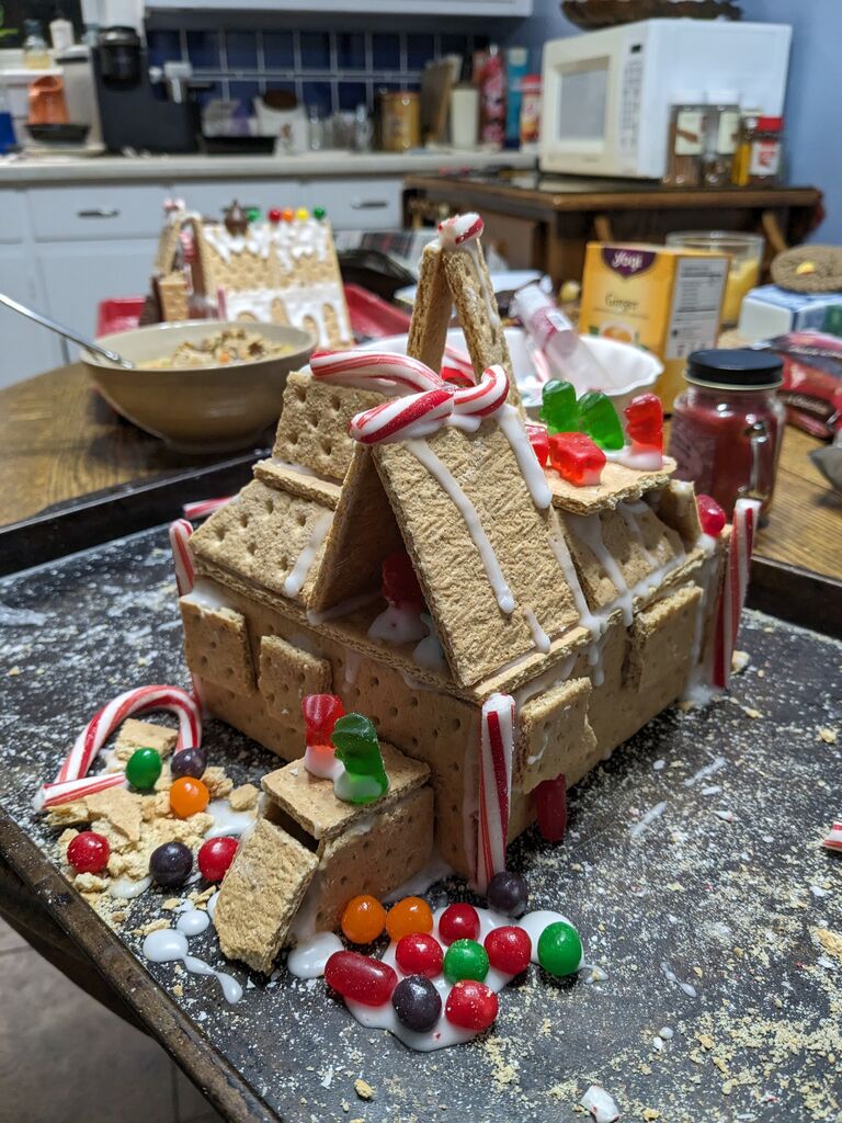 In a month of festivities, Adam and Gina participate in their own "Gingerbread" house competition. Pictured here is Adam's gummy bear retreat and nativity scene. 