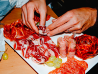 Person making charcuterie board