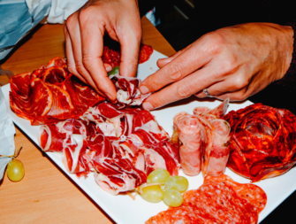 Person making charcuterie board