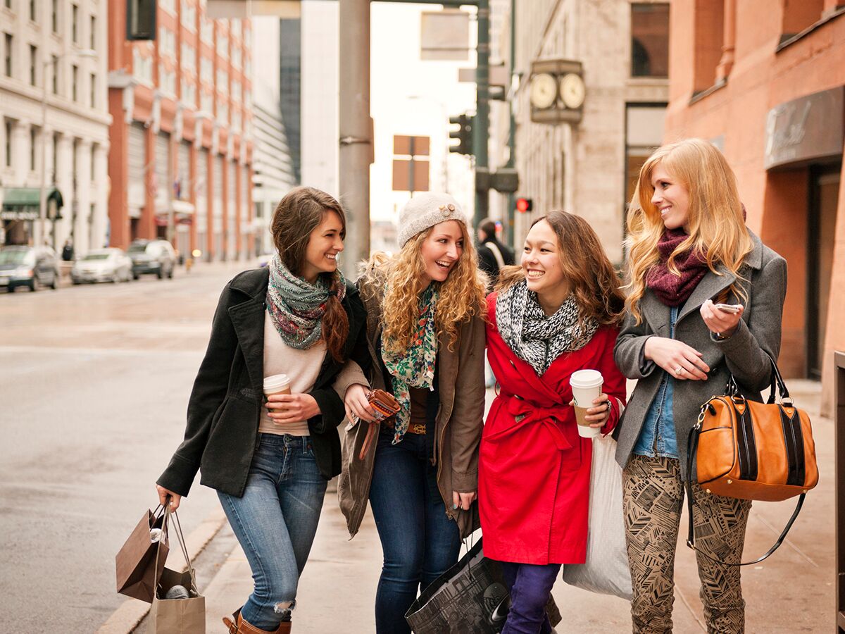 Denver Bachelorette Party - four women walking arm in arm in downtown denver