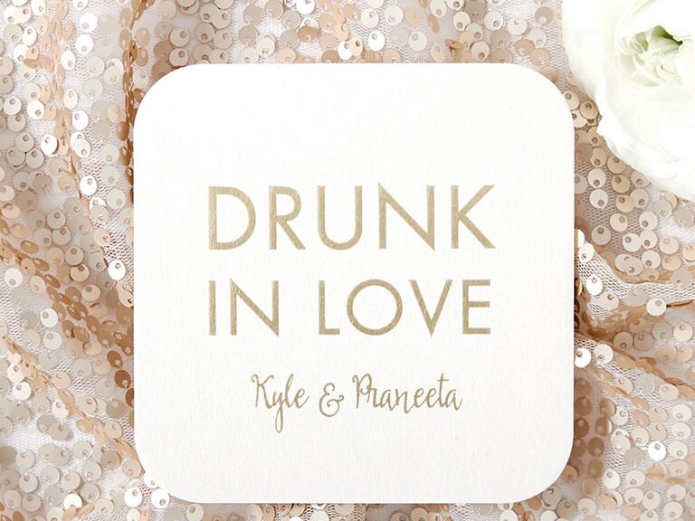 'Drunk in love' and couple's names in gold metallic type on white square coaster with rounded edges 