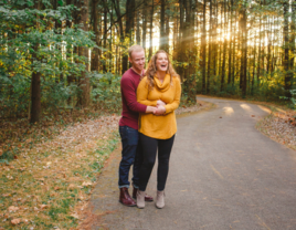 Couple hugging and smiling in woods in Ohio during fall