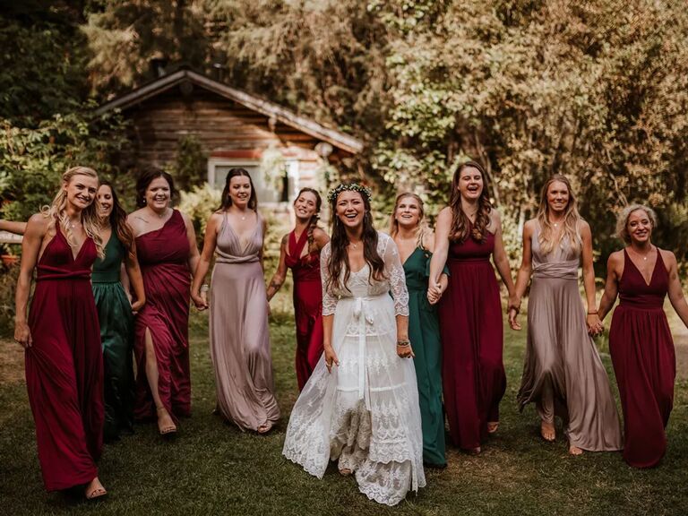 real wedding photo of mismatched ruby, rose quartz and emerald jewel-tone wedding party dresses