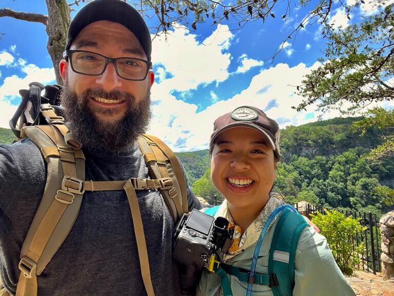 About a month after we adopted Dean, Dennis suggested that we should take a hike at Cloudland Canyon State Park before it got too hot. While we were at an overlook, Dennis suggested taking a nice photo with his camera. As we were posing for a photo, Karena asked when the shutter would go off and Dennis turned instead to propose! He was taking a video the whole time, and Karena said yes.
