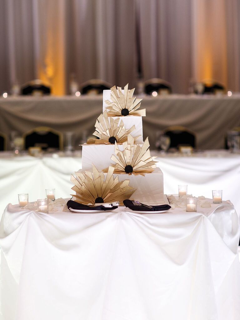 NYE wedding cake with gold art deco fans decorating each tier