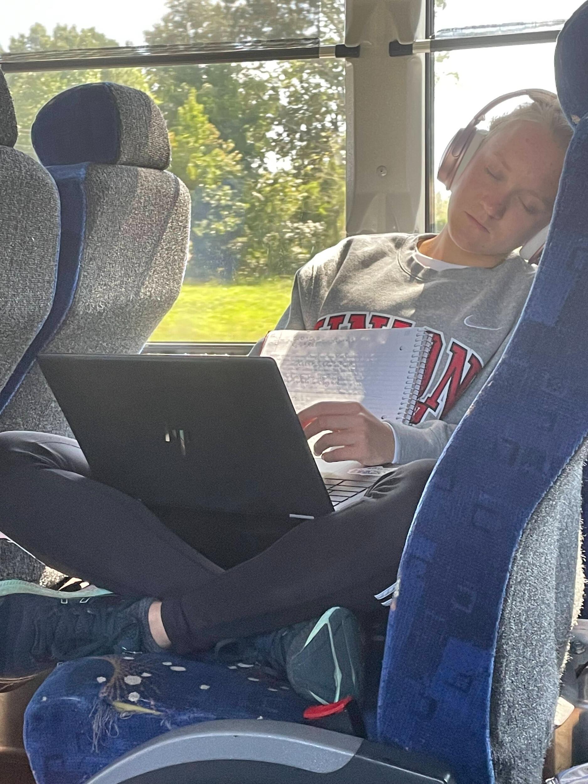 Caleb snapped a picture of Ayla when she was 'resting her eyes' while doing homework on the cross-country bus!