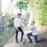 Couple getting engaged with dog