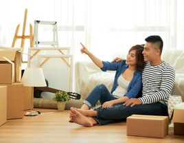 Couple sitting on the floor of their new home