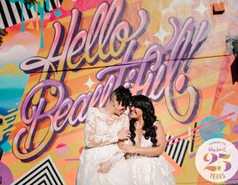 Brides posing in front of '90s-inspired graffiti wall