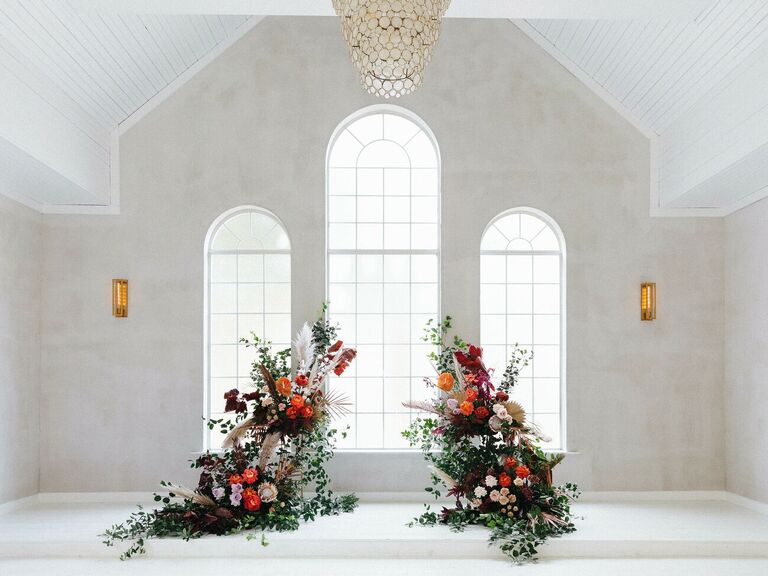 Colorful deconstructed arch in all-white chapel venue