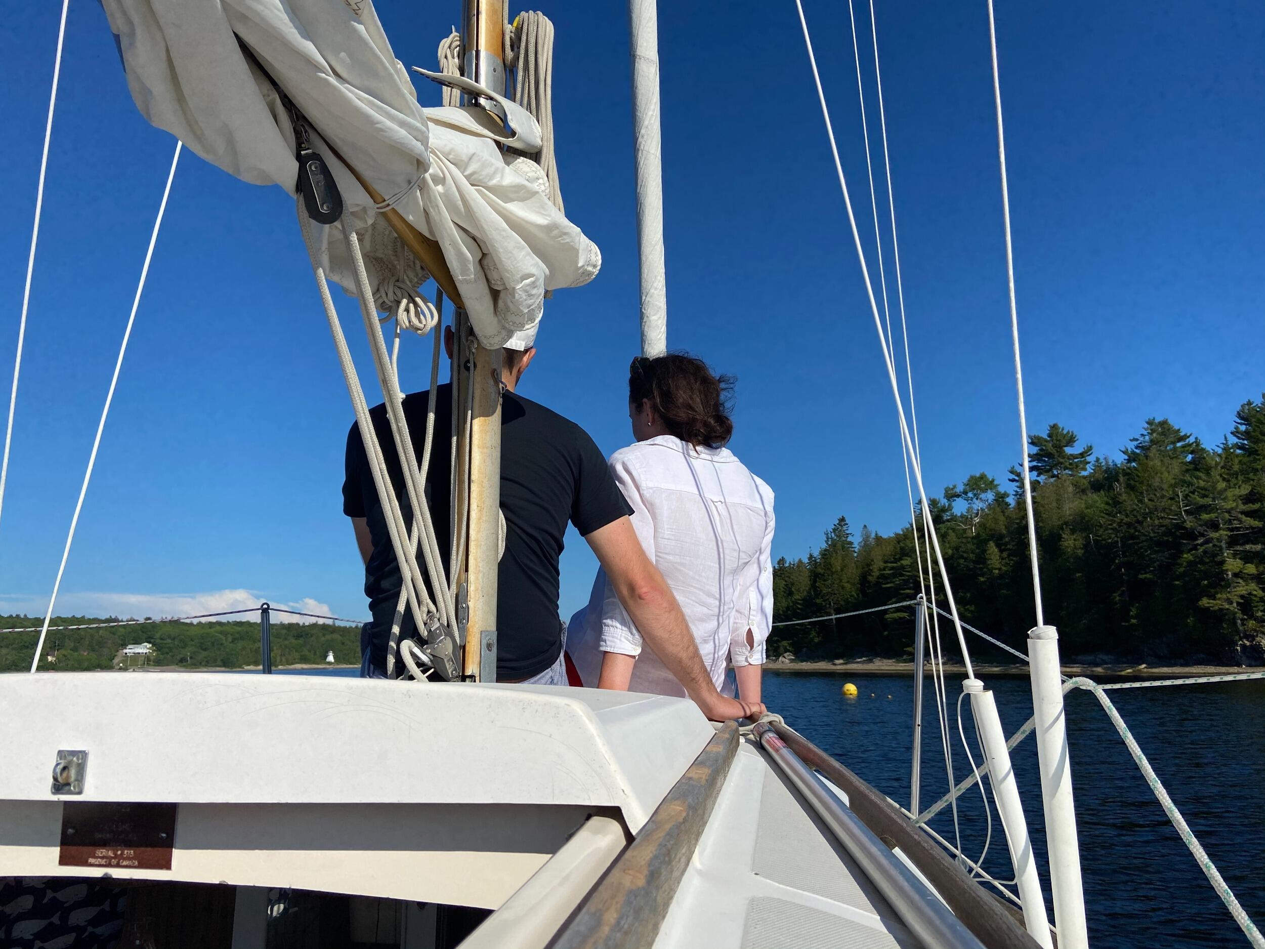Our first photo, a sneaky picture by Chrissy, and Chris's first (of many) sailing experiences ⛵