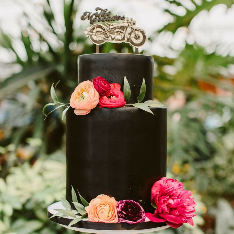 Two-tier black wedding cake with motorcycle cake topper