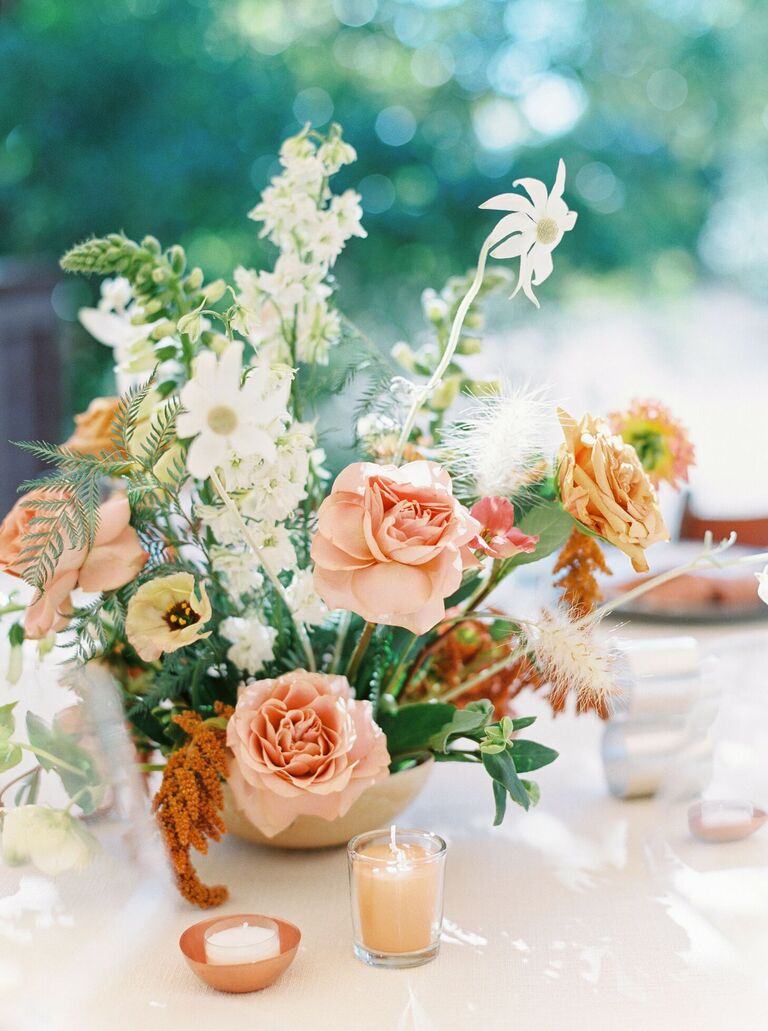 Loose floral centerpiece with roses and daisies