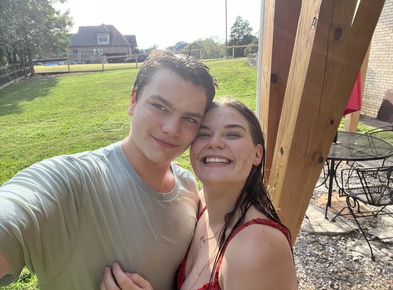An impromptu water hose fight started by the bride who was sadly defeated shortly before taking this picture