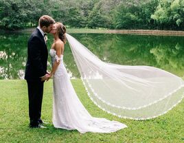 bride and groom kissing outdoor wedding portraits