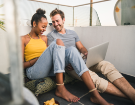 Couple listening to music on laptop