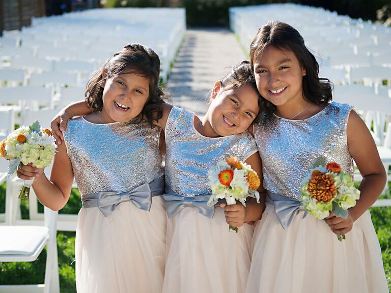 Junior bridesmaids pose at a wedding. 