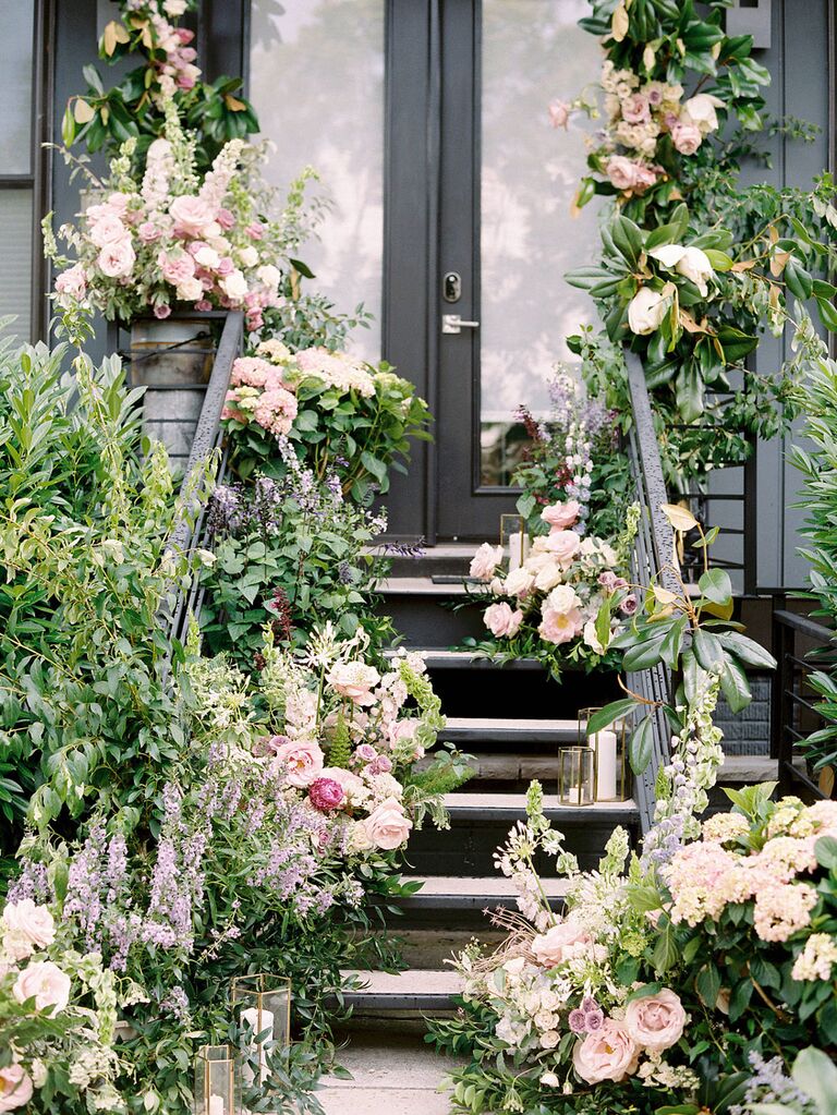Stoop decorated with lush wedding flowers and candles