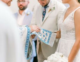 A couple participate in a traditional Romanian wedding ceremony.