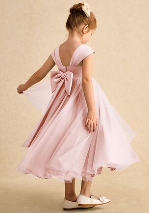 Chic and sweet, the Chickadee flower girl dress is crafted with a smooth matte satin bodice and a voluminous pleated tulle skirt that twirls with every step. Finished with a delicate sweetheart neckline, a V-back, and a large satin bow, this ankle-length ballgown is an enchanting choice for your celebration.
