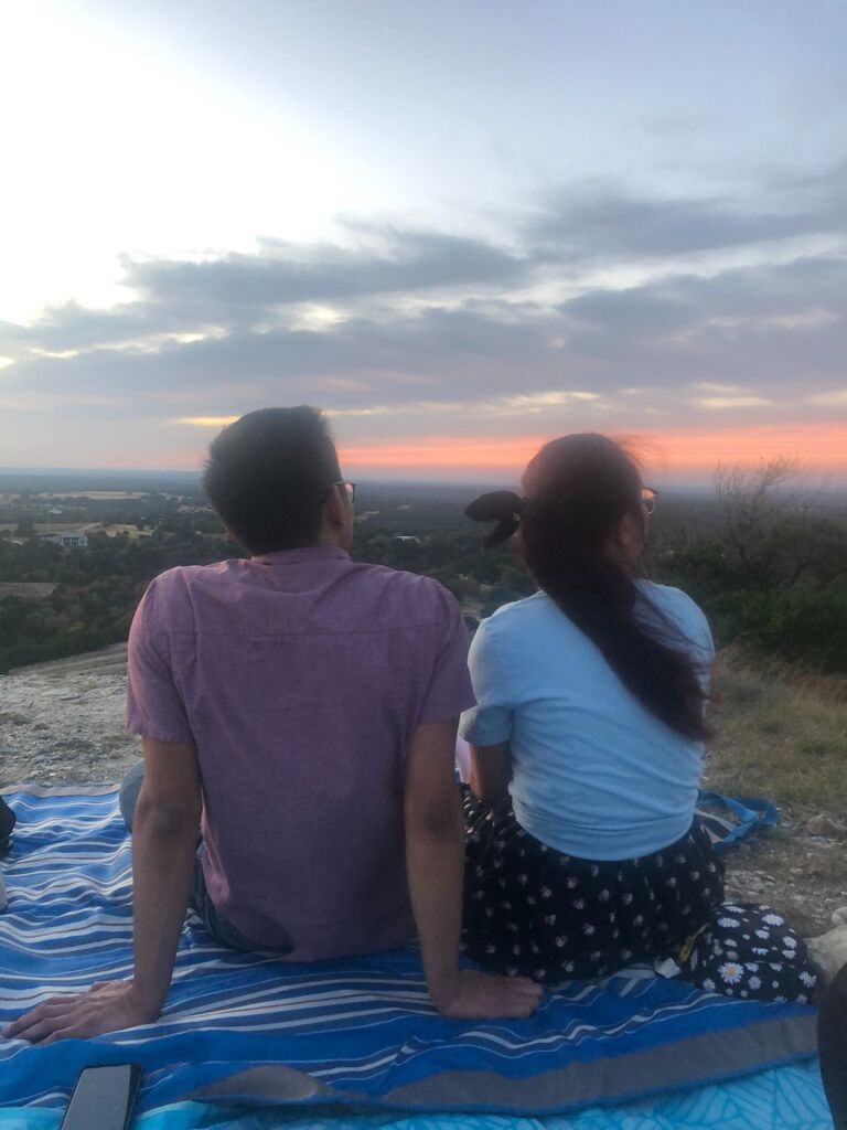 At the end of the day, having a picnic viewing the sunset.
Steven knew of a location right outside of Austin where stars could be more visible. The picture was taken by Natalie's friend and matron of honor, Tina.