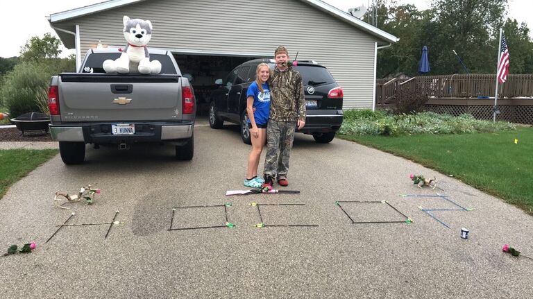 Jonathan laid out in the rain to ask Elle to homecoming 
