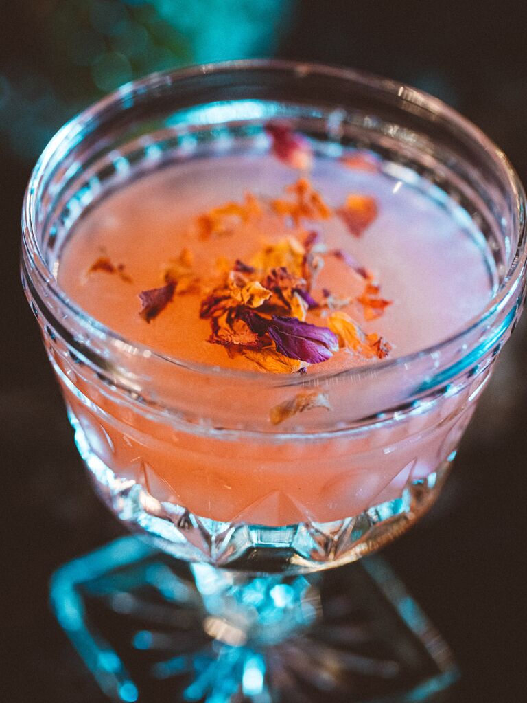Close up of cocktail with dried flower garnish at Phoenicia romantic restaurant in Seattle