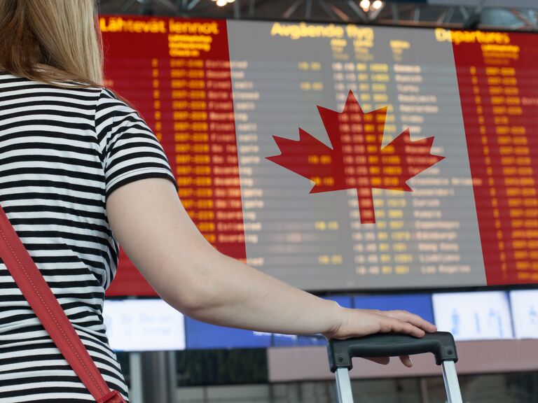 Woman looks at the scoreboard at the airport