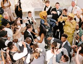 Guests dance around the happy couple.