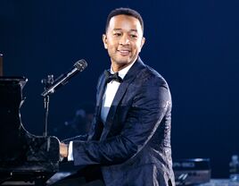 John Legend performing at piano