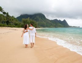 Couple walking on beach in Hawaii 