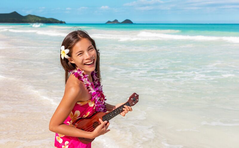 female ukulele player on the beach