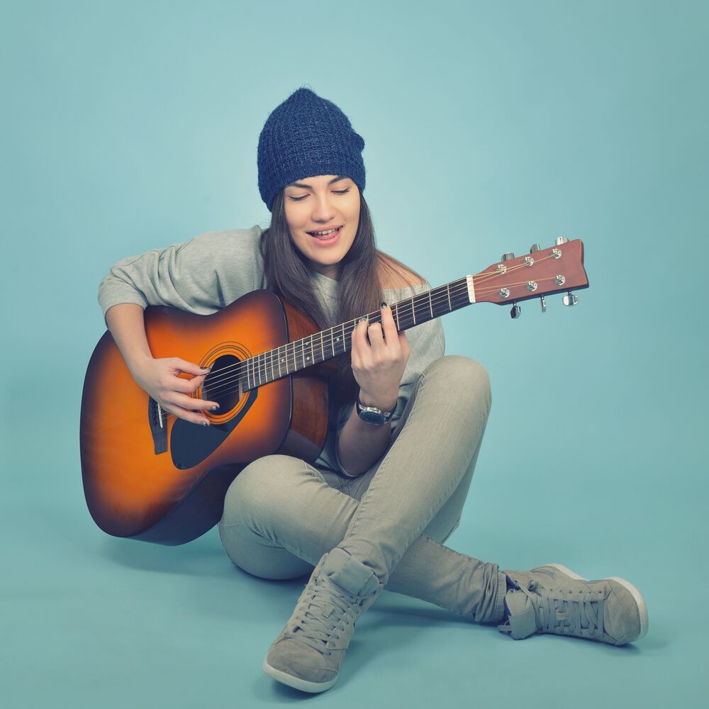 acoustic singer guitarist in a beanie